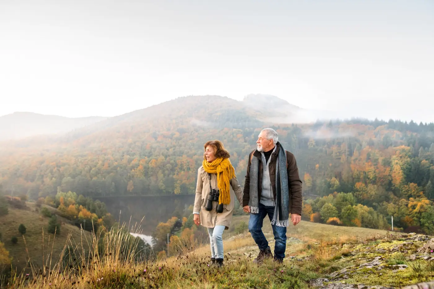 Couple walking a hillside trail representing investor self-custody
